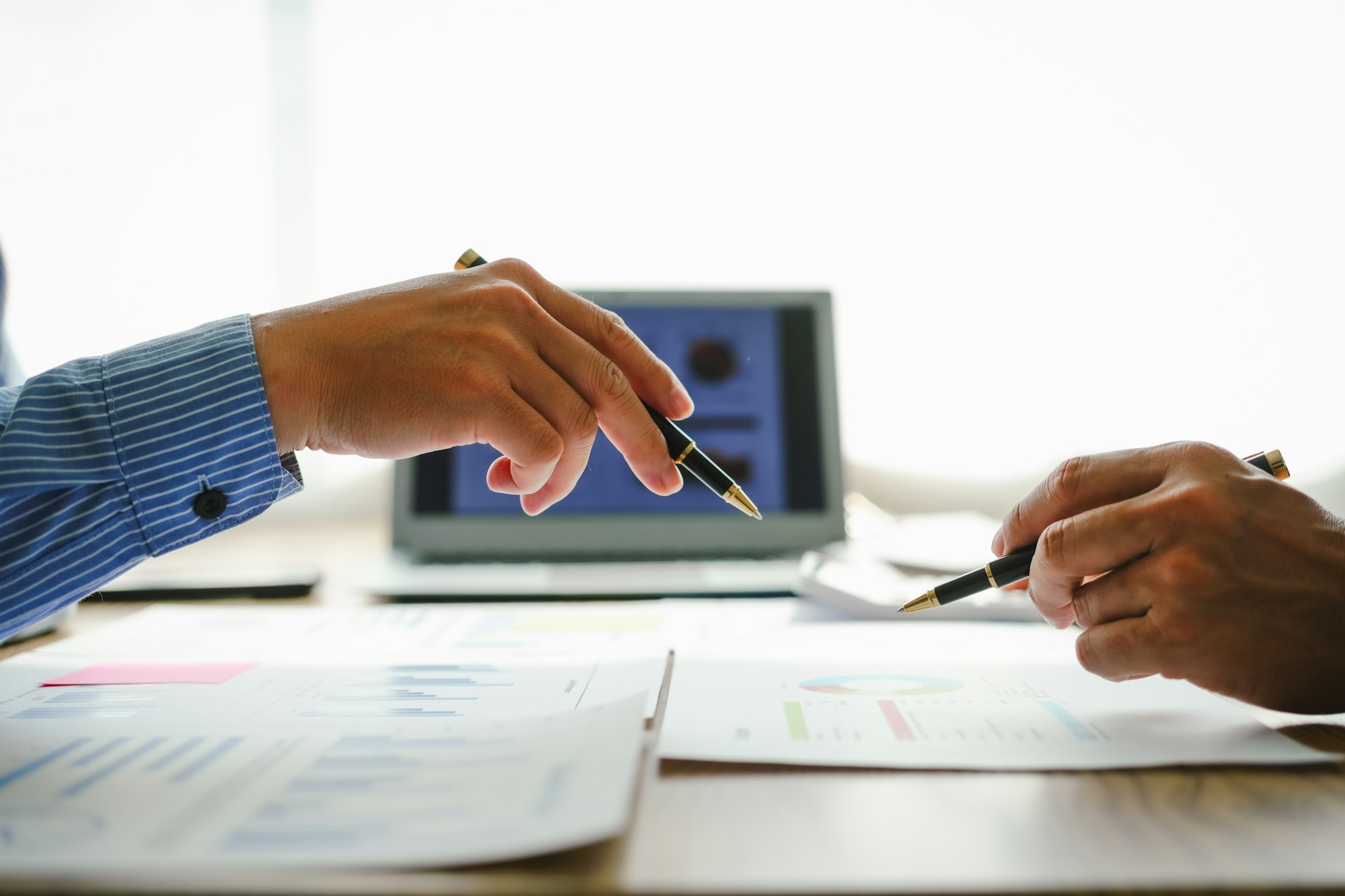 Desk-bound businessman calculates figures, verified accounts, and collaborates in discussions.