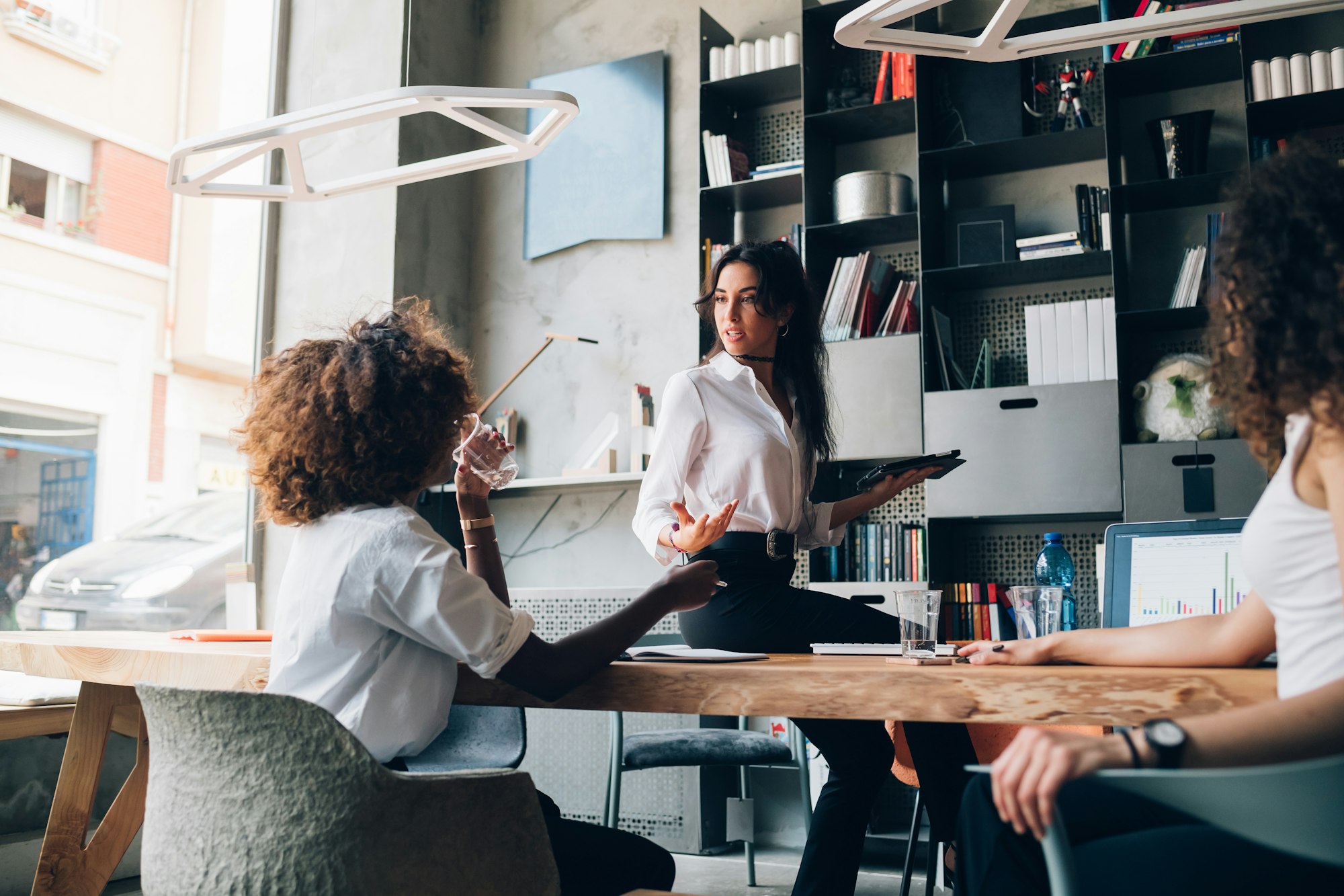 young multiracial businesswomen having informal talk in coworking office